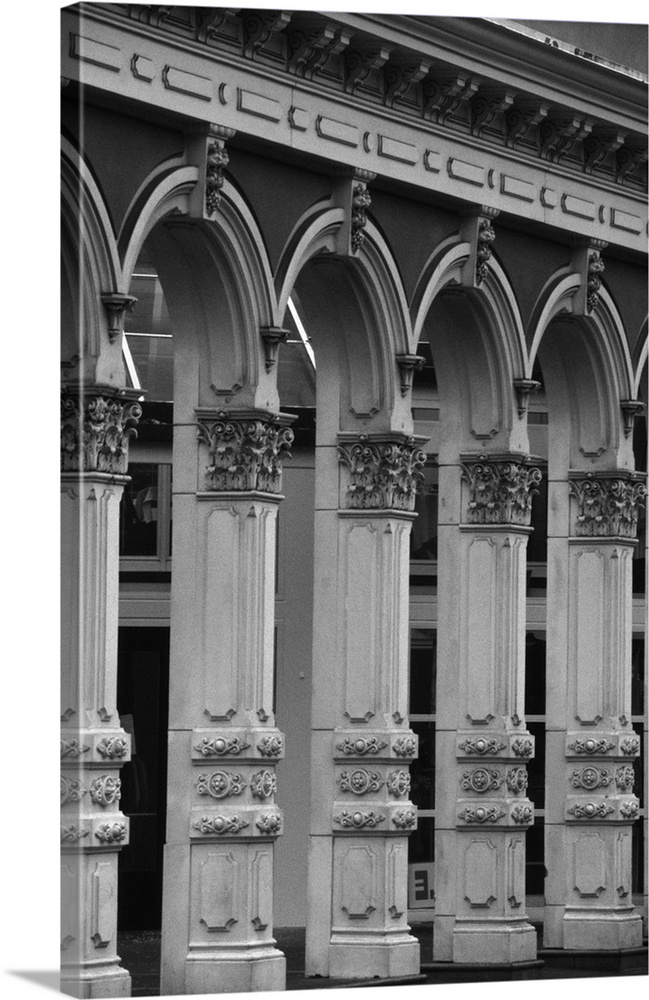 Black and white photograph of decorative pillars on the side of a building.