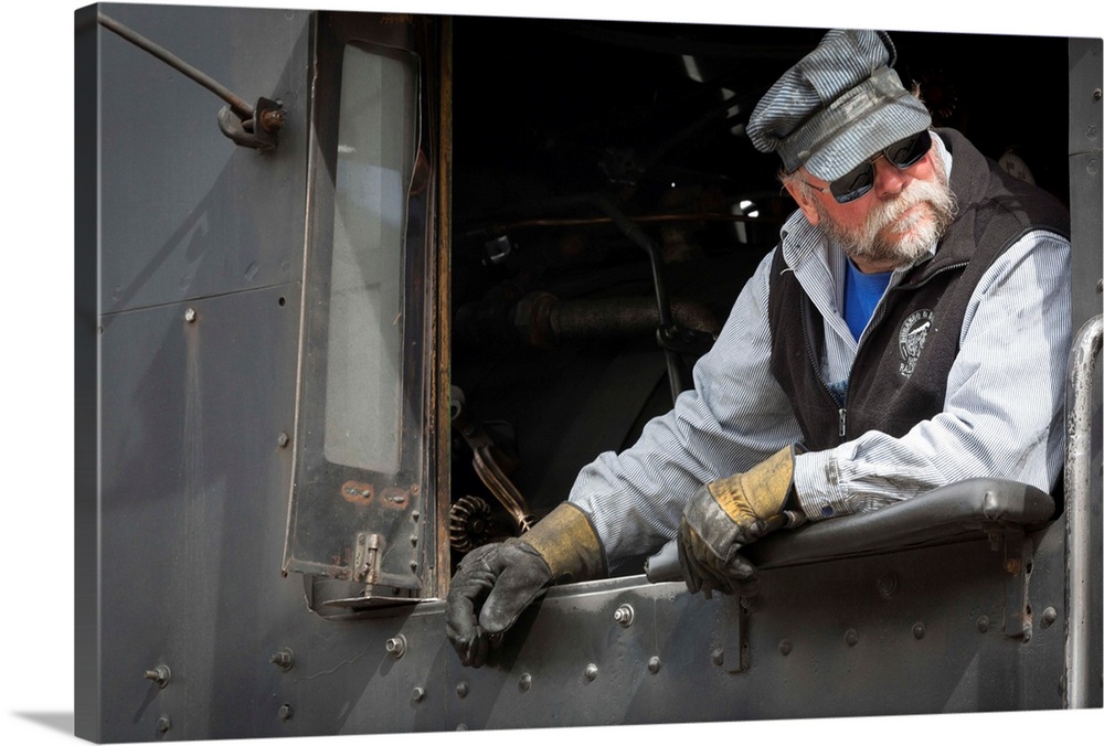 Photograph of a train engineer in vintage clothes.