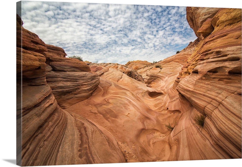 Landscape photograph of the sandstone rock formations with blue cloudy skies above in Valley of Fire State Park, Nevada.