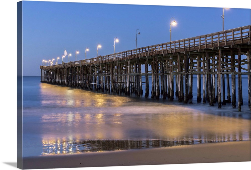 Photograph of Ventura pier lit up at night.