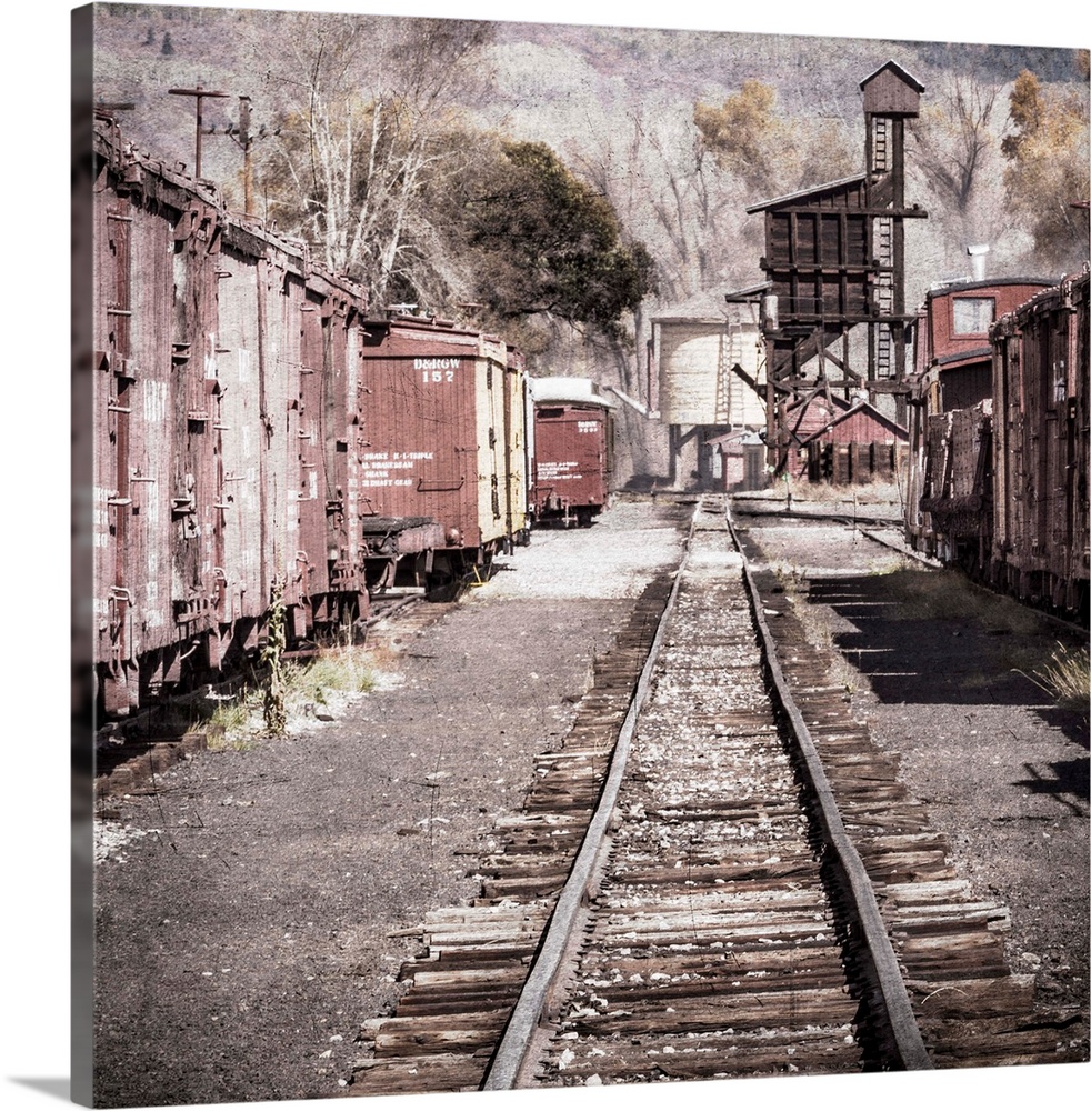 Photograph of a railroad passing through an old train yard.
