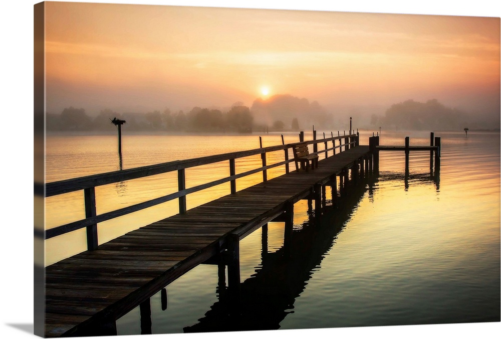 Photograph of a dock on the Wicomico River with a hazy sunrise above, Maryland.