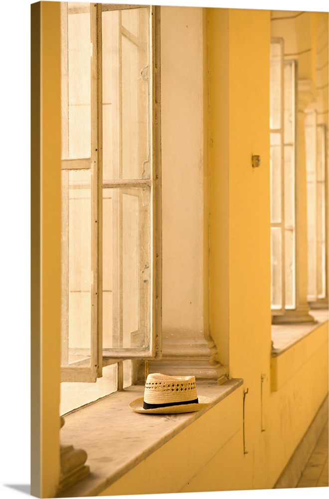 Minimal photograph of a hat resting on a window ledge in The Museum of the Revolution, Cuba.