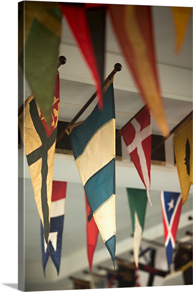 Close-up photograph of flags hanging on the ceiling of a yacht club.