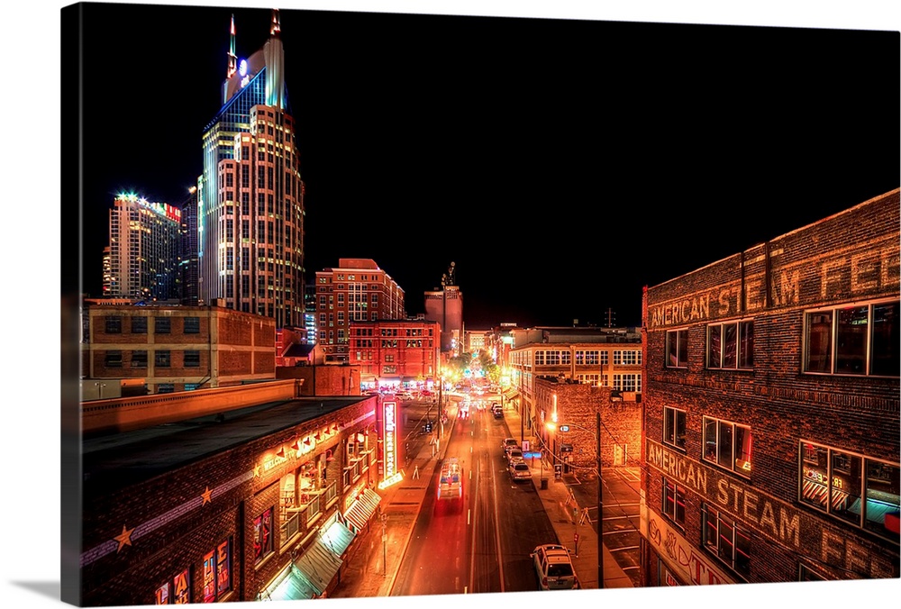 Downtown Nashville at night, showing hustle and bustle of busy city.