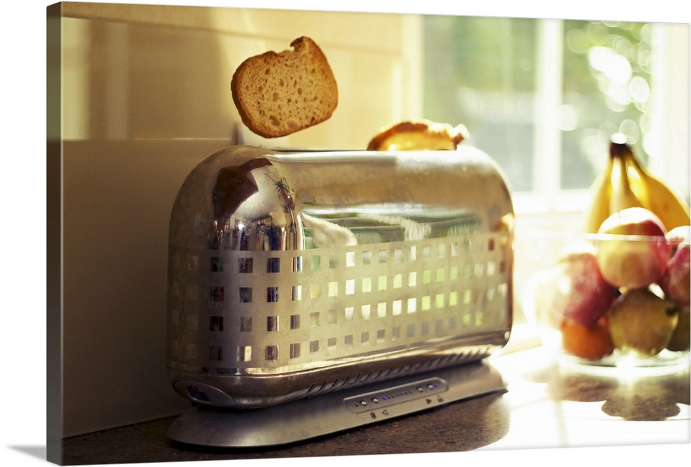 A classy and stylish chrome checkered toaster pops up a slice of toast on a bright and sunny morning. Vibrant fruit and wi...