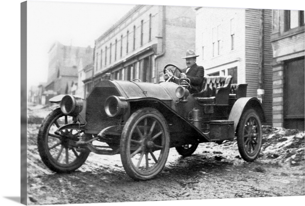 A man sits in his automobile in the aftermath of flood caused by a dam break in Pueblo Colorado in 1921.