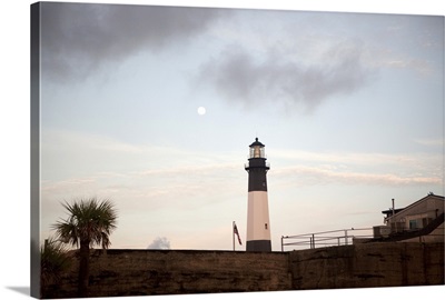 A full moon sets over Tybee Island Lighthouse near Savannah, GA