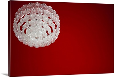 A glass chandelier against a red ceiling