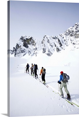 A group of skiers in the backcountry on a clear day