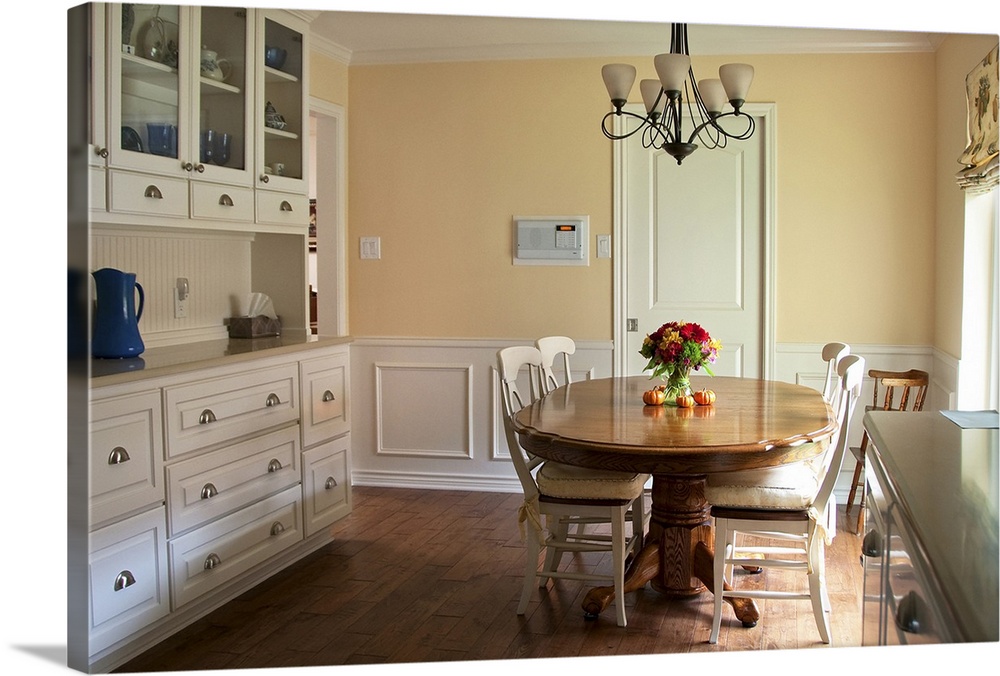 Yellow and white kitchen with wood floor.