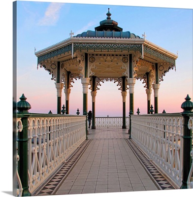 A lone figure and an almost symmetrical shot of an ornate seaside bandstand.