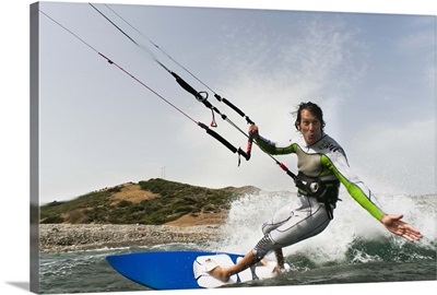 a man kite surfing off the coast of parque natural del estrecho