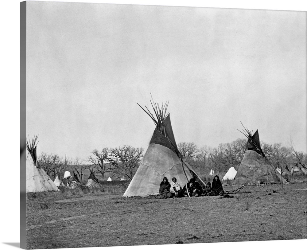 A Comanche Indian family sits outside their teepee in the Iron Mountain's Camp, 1873.