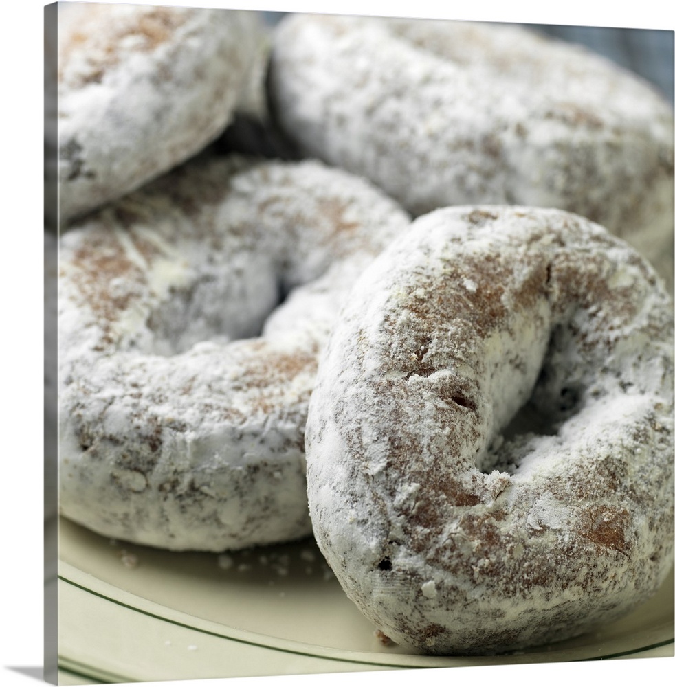 A plate of sugar donuts aka 'doughnuts'