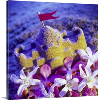 A sand castle and orchid flowers