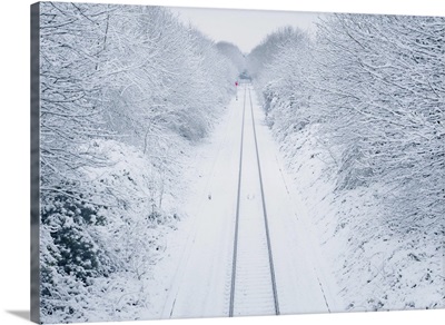 A snowy railway line vanishes into the distance