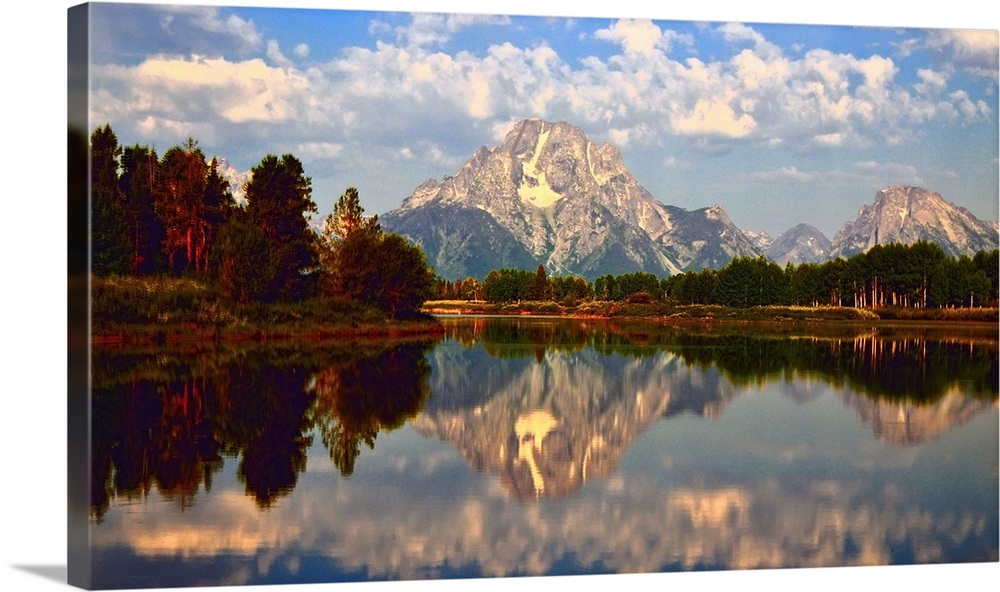 Mount Moran reflected in the still water of the Snake River in Grand Teton National Park during the early morning