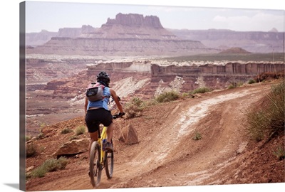 A woman bikes the White Rim trail in Utah
