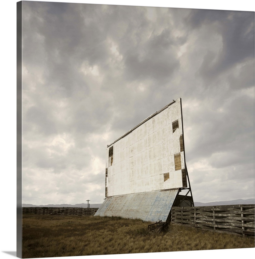 Abandoned drive-in movie screen in an overgrown field in Nebraska.