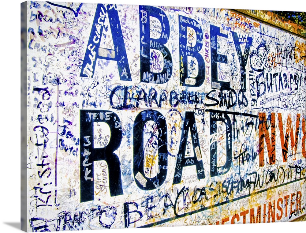 Famous Abbey Road road sign covered with grafitti from Beatle fans