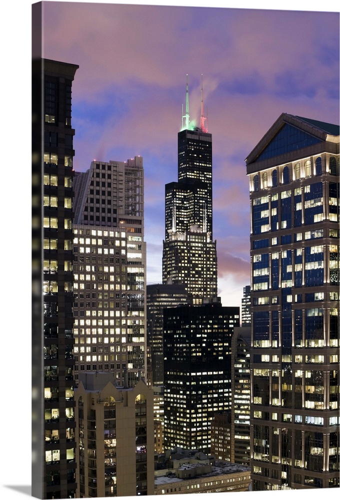 Aerial view of buildings in the Chicago Loop, including Sears Tower and City Hall at dusk.
