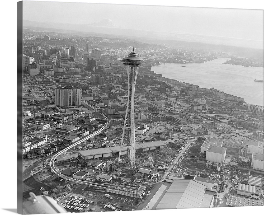 An aerial view of Seattle prior to the World's Fair shows the new Space Needle and monorail snaking through the downtown. ...