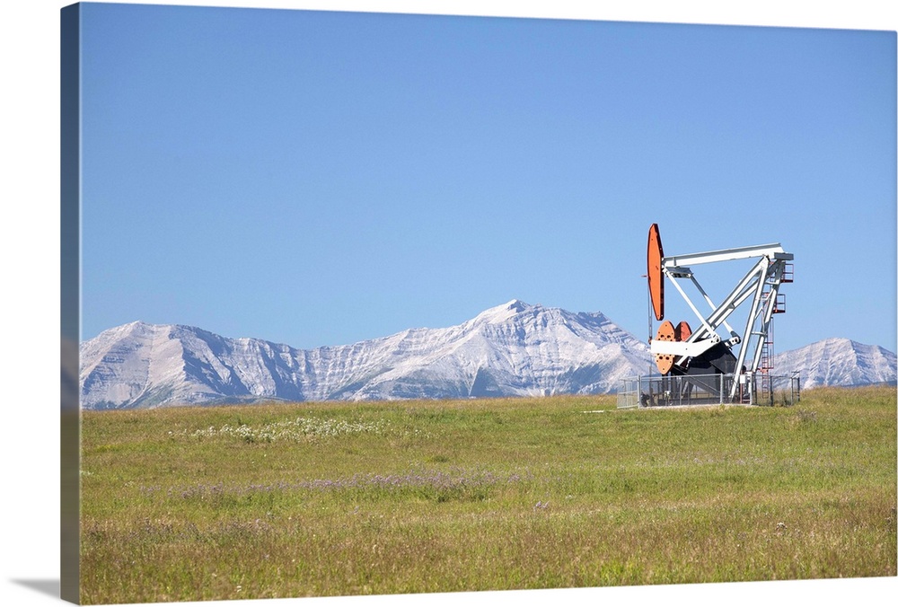Pumpjack With Mountains And Blue Sky In The Background