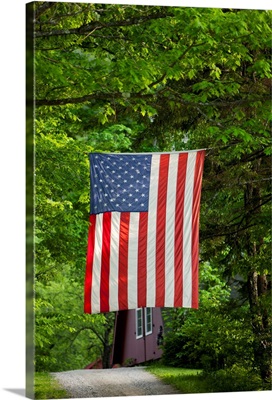 American Flag Hanging Above Gravel Road