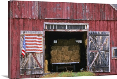 American flag hanging from a barn door