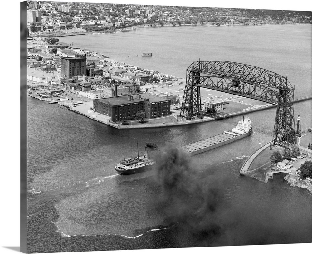 An iron ore cargo ship passes under the Aerial Lift Bridge as it enters Lake Superior.