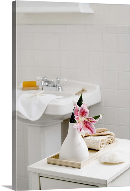 An orchid flower in a white vase in the bathroom | Great Big Canvas