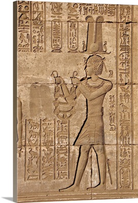 Ancient Egyptian relief depicting Trajan carrying offerings to the goddess Hathor