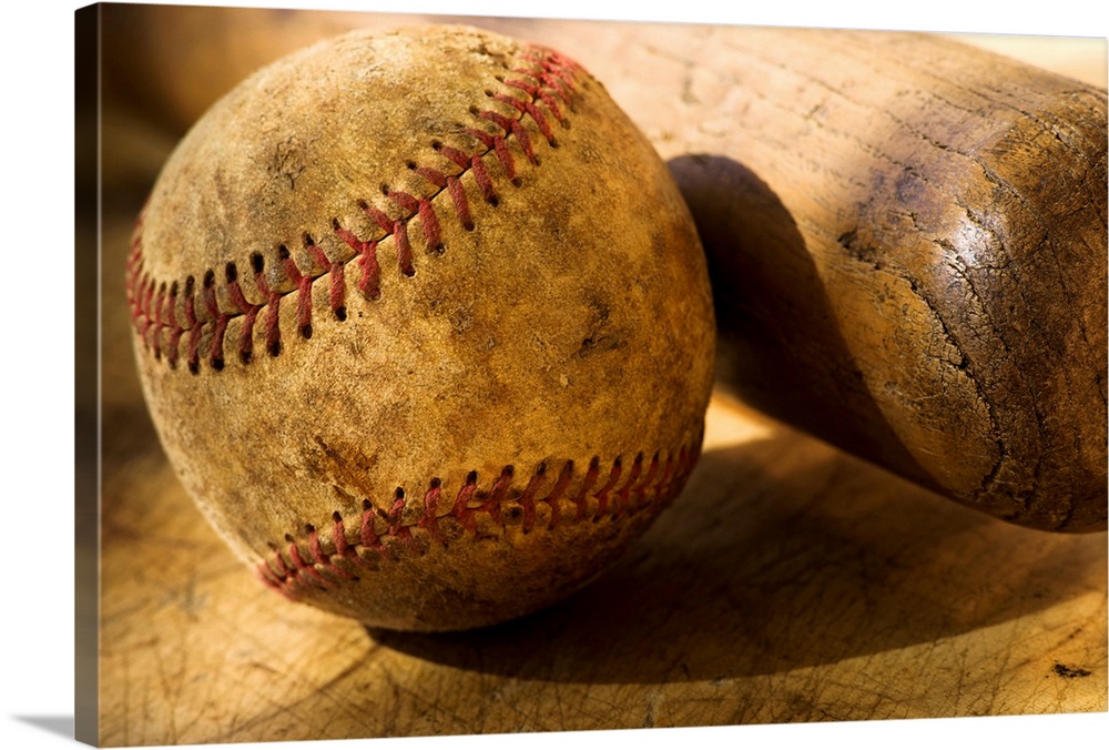 Distressed baseball and bat in this horizontal photograph.