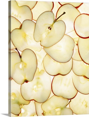 Apple slices backlit and arranged in abstract graphic pattern