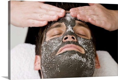 Applying skincare face mask with salt