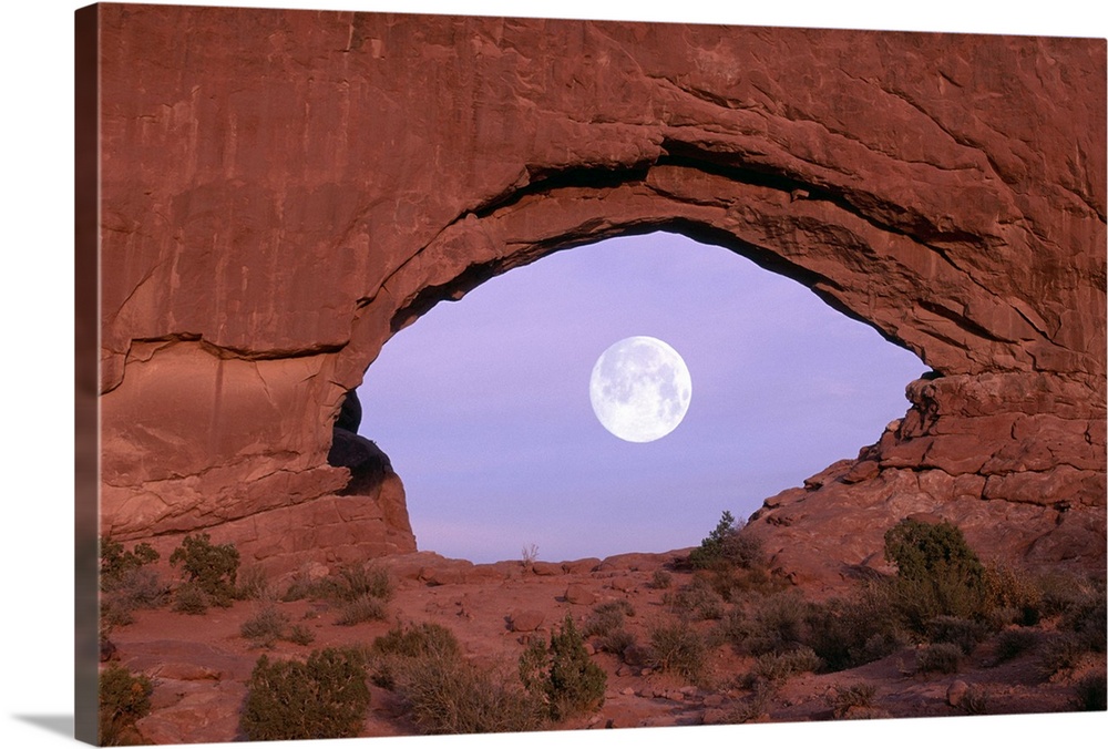 PHOTOGRAPHER AT WINDOW AT ARCHES NATIONAL PARK
