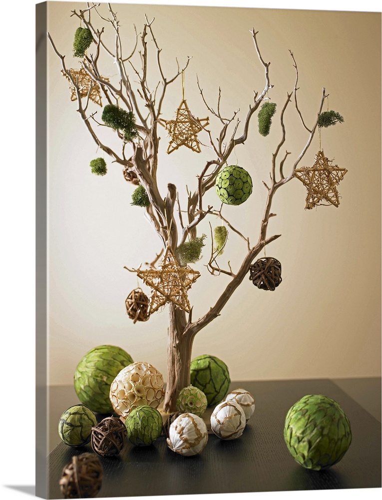 Artwork composed from dried tree branch and paper ornaments