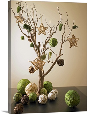 Artwork composed from dried tree branch and paper ornaments