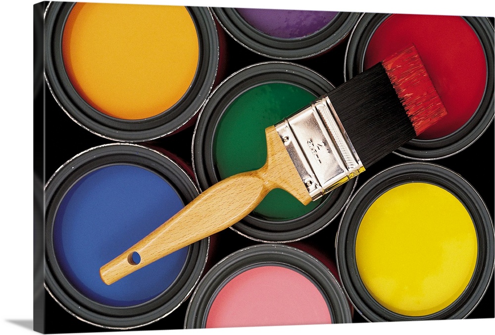 Assorted colors of paint in cans with brush