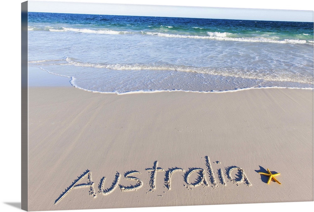 Australia written on a sandy beach. Pristine beach with a yellow starfish. South Australia.