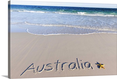 Australia written on a sandy beach with a yellow starfish