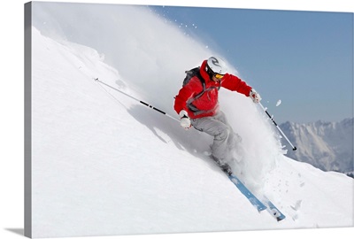 Austria, Saalbach, male skier turning in snow on slope