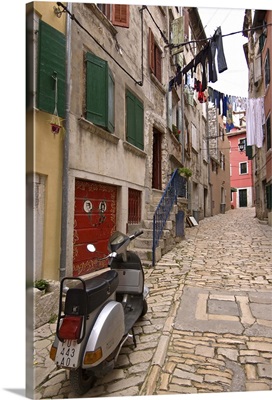 Backstreets of Rovinj, Croatia with a scooter and hanging laundry