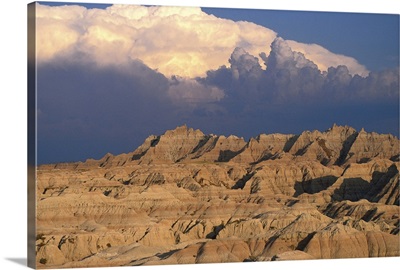 Badlands landscape with thunderstorm above