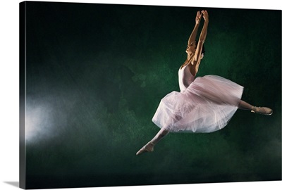 Ballerina leaping across stage