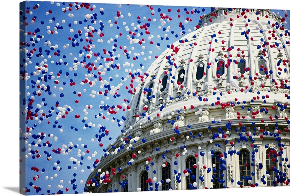 Red, white, and blue balloons float over the U.S. Capitol dome in Washington, DC, in celebration of the bicentennial of th...