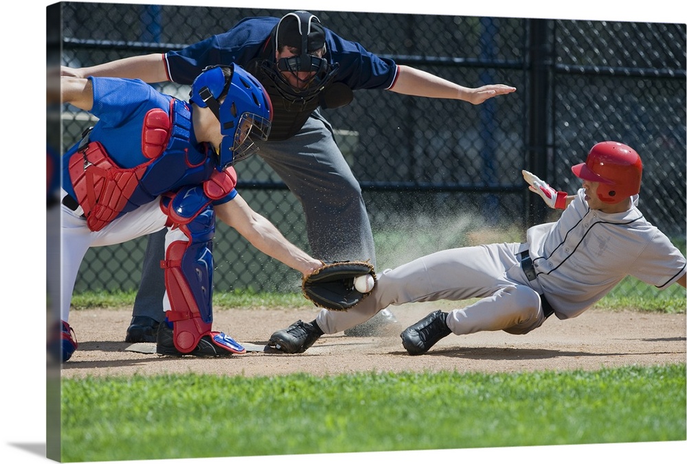 Baseball player sliding into home plate