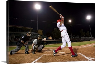 baseball players with batter swinging, USA, California, San Bernardino