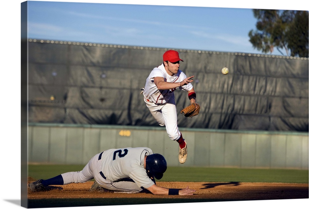 USA, California, San Bernardino, baseball runner sliding for base and baseman leaping for catch